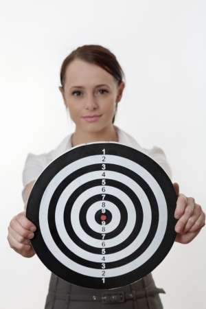 woman in a business out fit holding up a targetの写真素材