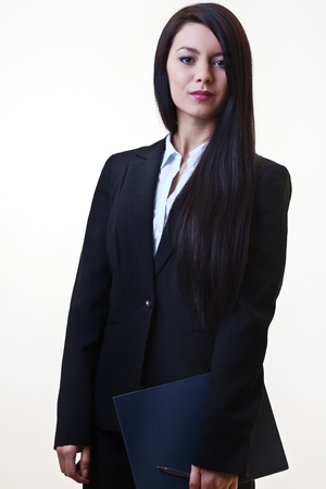 young office worker standing holding a note bookの写真素材