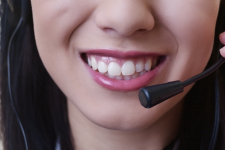 close up of a woman mouth using a phone headset to talkの写真素材