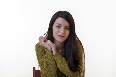 A beautiful young woman relaxing on the wearing a jumper and looking at camera. の写真素材