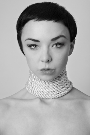 sexy woman with rope wrapped around her neckの写真素材