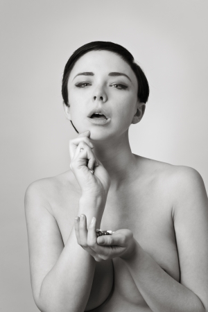 sexy naked woman with a handful of pillsの写真素材