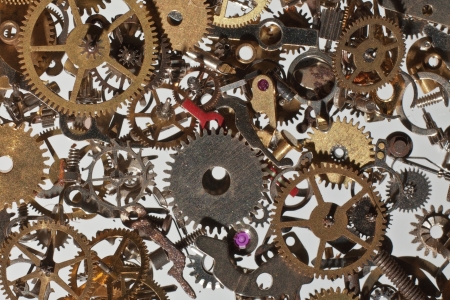 many parts and cog from a watch looking down from above background