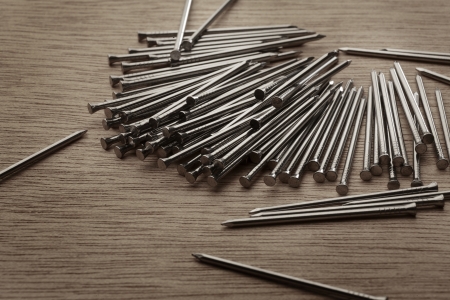 pile of nails shot on a wooden backgroundの写真素材