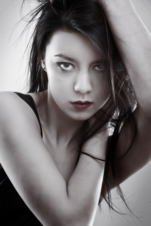 woman grabbing her hair shot in the studioの写真素材