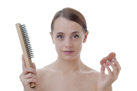 Portrait of beautiful female model exfoliating skin with a wire brushの写真素材