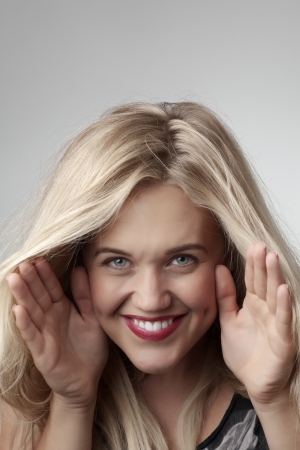 Close-up portrait of a beautiful young girl making funny faceの写真素材