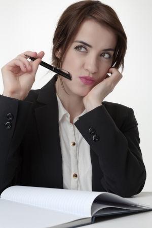 Pretty businesswoman working and and deep in thoughtの写真素材