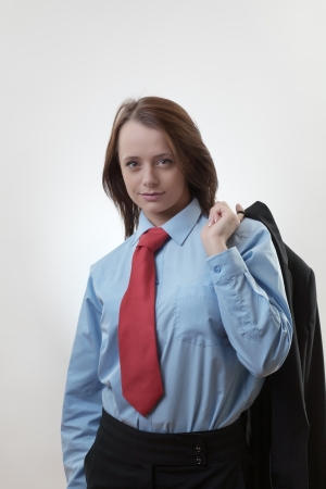 Pensive businesswoman standing wearing a tieの写真素材