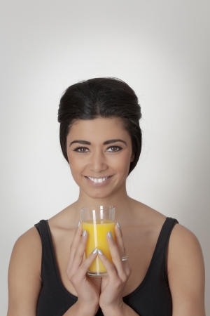 asian woman holding a glass of fruit juiceの写真素材