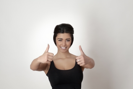Happy smiling asian woman with thumbs up gestureの写真素材