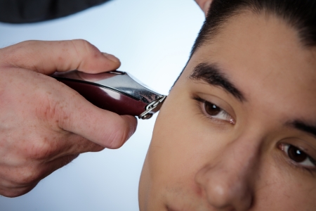 close up shot of man getting his hair cutの写真素材