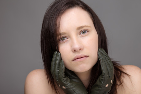 head shot of a young woman shot in the studio looking into camera model is wearing leather driving glovesの写真素材