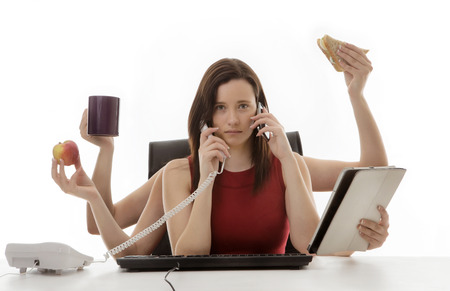 busy business woman multitasking in the office with six armsの写真素材