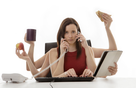 busy business woman multitasking in the office with eight  armsの写真素材