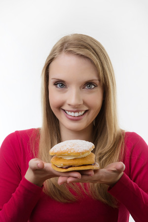 woman about to eat a cream cake she's looking very happy の写真素材
