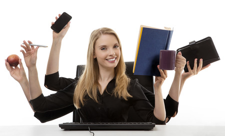 busy business woman multitasking in the office with six armsの写真素材