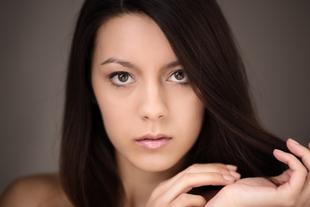 natural beauty headshot of young woman shot in the studioの写真素材