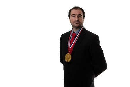 Business man wearing a chocolate gold medal around his neck の写真素材