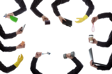 man  hands holding many different house hold object mostly cleaning products の写真素材