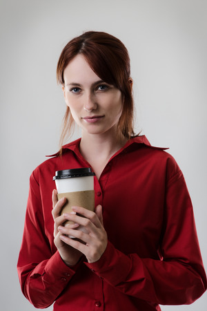 business woman holding a take away paper coffee cupの写真素材