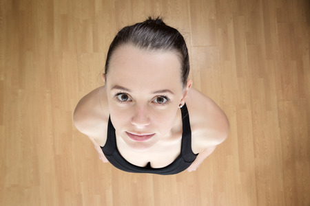 fitness woman looking up at camera at a high view point above the modelの写真素材