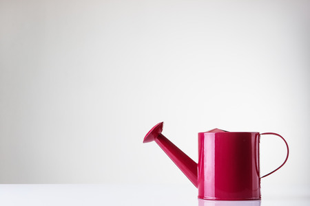 small kids watering can shot in the studio on white backgroundの写真素材
