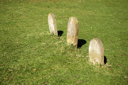 Three small blank grave stones in a line