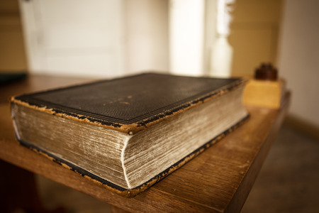 old book worn out on a table topの写真素材