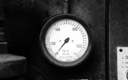 Old fuel gauge on the wall showing emptyの写真素材