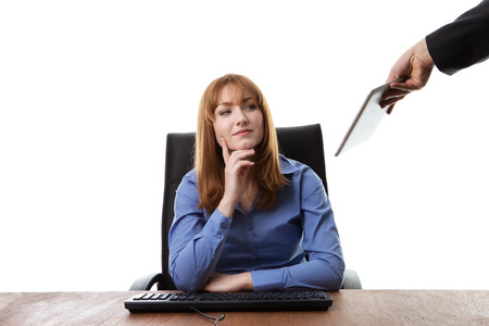 business woman sitting at her deskの写真素材