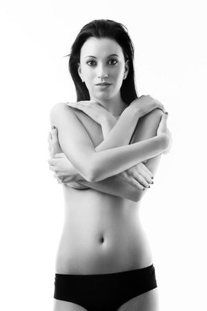 black and white image nude woman covering her breast with many armsの写真素材