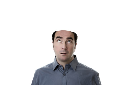 man looking up missing the top of his headの写真素材