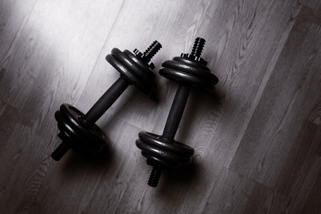 dumbbells shot from above on a wooden floorの写真素材