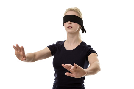 woman wearing a blindfold not sure what to doの写真素材