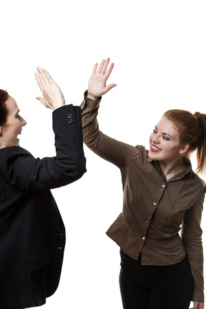 two business woman high fiving each otherの写真素材