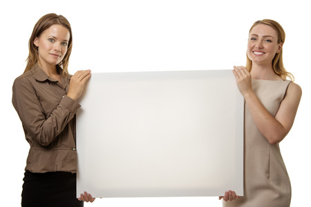 two business woman holding up a boardの写真素材