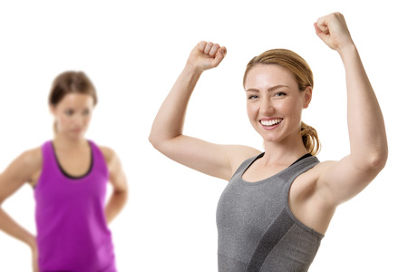 two fitness woman one in front celebrating and the other behind up setの写真素材