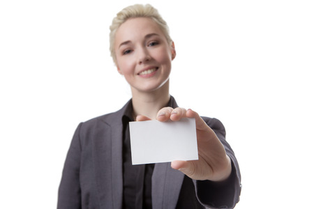 Studio shot of a business woman holding a small white blank cardの写真素材