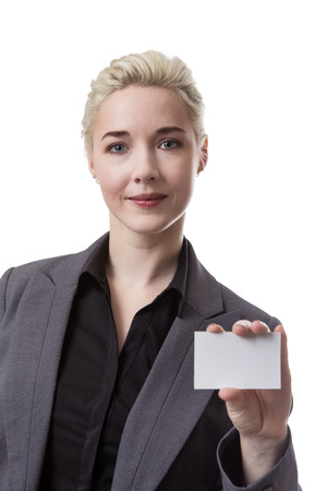 Studio shot of a business woman holding a small white blank cardの写真素材