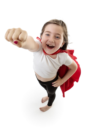 Pretty young girl posing with her right arm in the air ready to flyの写真素材