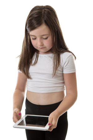 Pretty young girl is enjoying playing on her tablet computerの写真素材