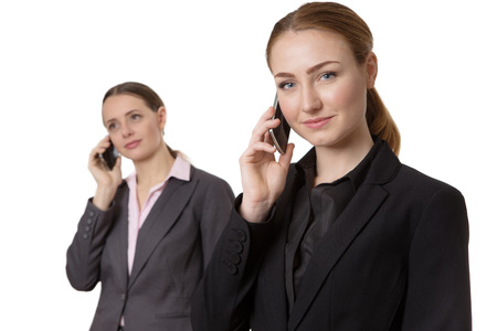 two business models, both using the mobile phones.  isolated on whiteの写真素材
