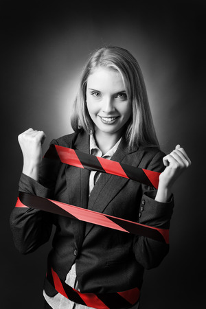 Business model is tied up with a black and red stripe tape wound around her.の写真素材