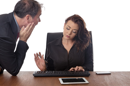 business man looking at a female work colleague boobsの写真素材