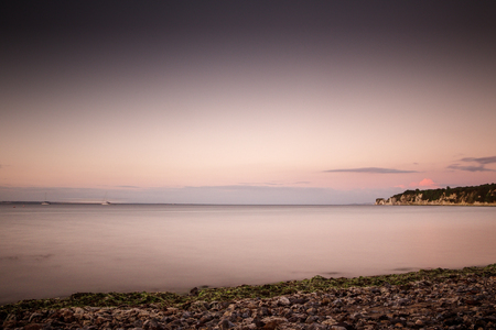 seascape shot in dorset looking out and seeing old harry rocks in the distances using a long exposure timeの写真素材
