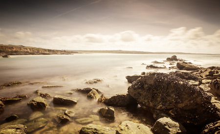 rocky beach in cornwall taken with a long exposureの写真素材
