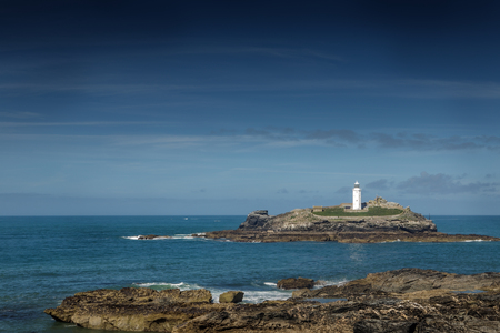 landscape shot of  the light house at Godrevy beachの写真素材