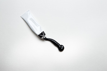 white paper background with a single paint tubeの写真素材