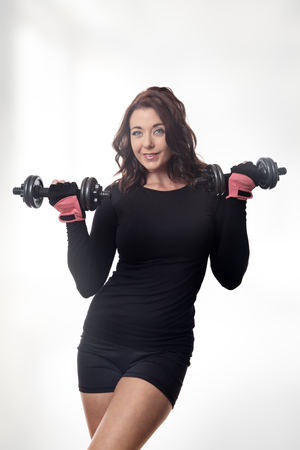 woman working out using dumbbellsの写真素材